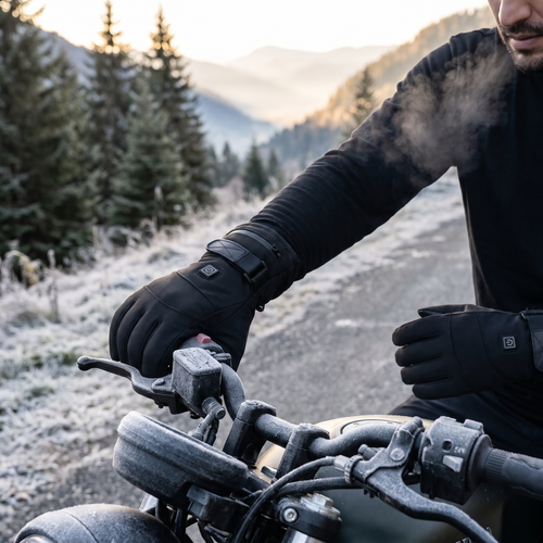 Man wearing black touch screen heated gloves on motorcycle handlebars on a frosty morning
