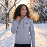 Woman on a winter park walk in a gray 31-zone heated hoodie