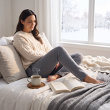 Woman relaxing at home in grey heated thermal leggings
