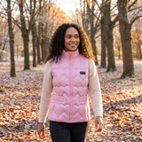 Woman on a park walk in a pink heart-quilted heated vest