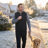 Man on a sunrise dog walk in a black 9-zone heated vest